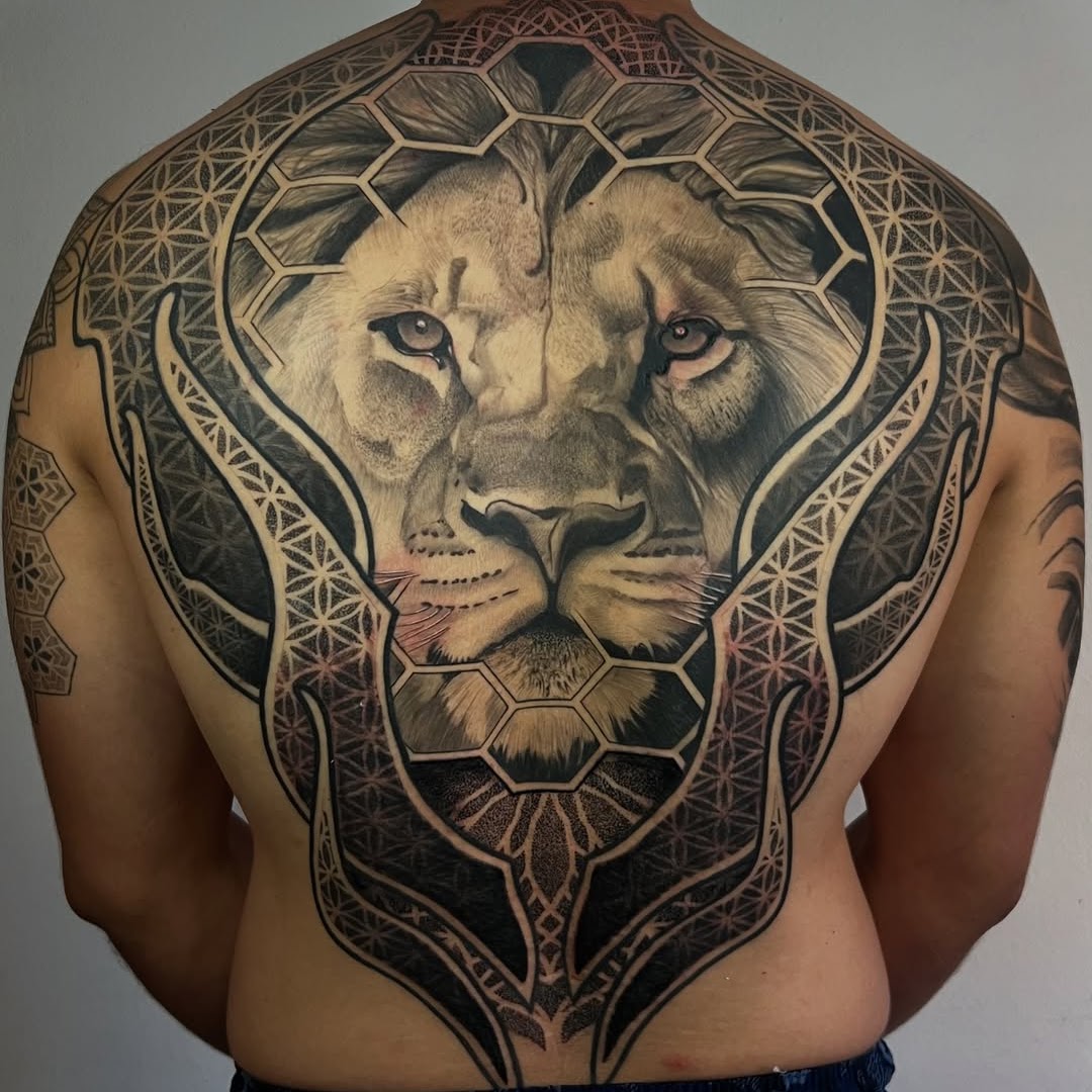 Full back ornamental geometric lion tattoo surrounded by sacred geometry — Caos Art Tattoo Santiago