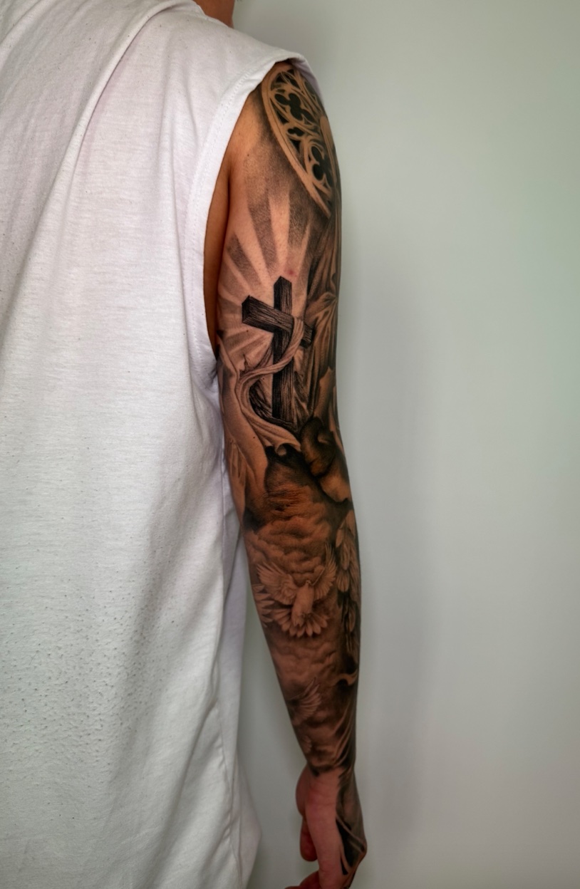 Manga completa religiosa con cruz — tatuaje realismo — CAOS Art Tattoo Chile